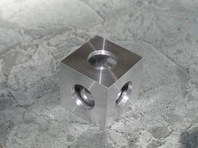 Photo 10  The machined ball in a cube.