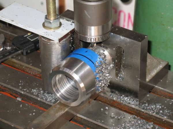 Machining the C-spanner slots.  The workpiece was bolted to the angle.  The workpiece sat on a piece of key steel.  The vertical tube fixed the lateral position.  This mean't I could rotate the workpiece and clamp into the right position for the next cut.