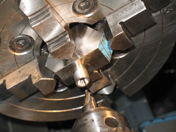 The hexagonal stock made it easy to index the workpiece as each port was machined.  Note that the hole is intentionally off centre in two directions.