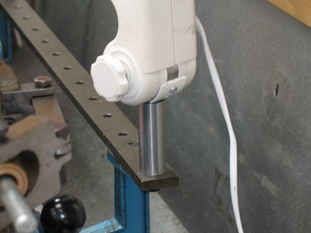 The support bolts straight onto the taper turning bar.  The hole is perfectly located to support a lamp.