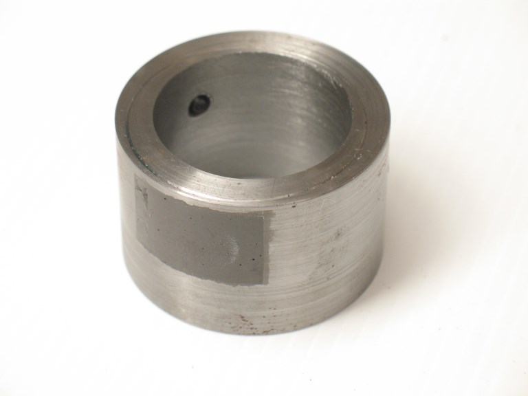 The existing bushing modified by potting a magnet in a milled slot.  A similar slot was milled on the other side to balance the bushing.