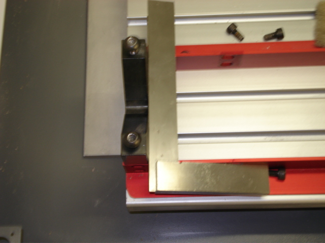 Move the block to the end of the fixture and use a square to align the block with the side rails.