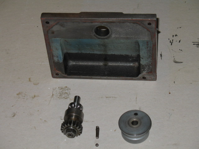 The cover with selector knob, spring and ball and gear.  The interlock pin can just be seen poking out on the right side of the cover.